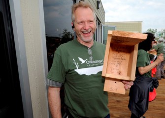 Peter Haun, from Fairmount, displays a box he helped build with a “Welcome Home” message for birds.