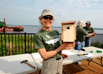 Onondaga Audubon member and Corps volunteer Ruth Florey with a breeding box to be installed along the shoreline.