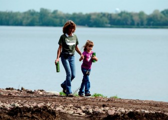 Karen Cahill and her daughter, Grace, walk along Onondaga Lake.