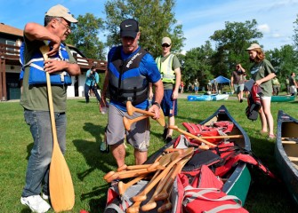 Volunteers collect equipment near the Syracuse Chargers Boathouse.