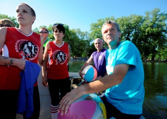 Members of Syracuse’s roller derby team (left), Assault City Roller Derby, head out to join the group waiting on the platform.