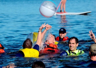 New York State Department of Environmental Conservation Commissioner Joseph Martens (center) gets ready to fist bump a beach ball back into the air.