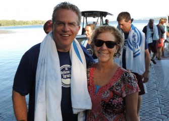 Onondaga County Legislators Tim Burtis (left), Brewerton, and Kathy Rapp of Liverpool, return to shore after enjoying an inaugural swim.