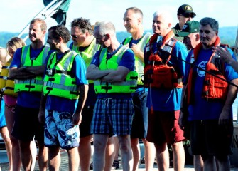 Those waiting to swim include Evan van Hook (center foreground), Honeywell Vice President of Health, Safety, Environment, Product Stewardship, and Sustainability; John McAuliffe (center background), Honeywell Syracuse Program Director; and NYSDEC Commissioner Joseph Martens (right of McAuliffe).