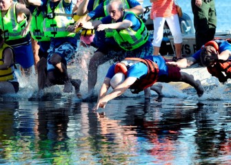 New York State Department of Environmental Conservation Commissioner Joseph Martens (center) leads the dive in this symbolic event celebrating 40 years of progress.