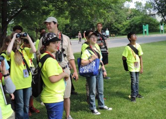 Students engage in hands-on activities throughout the week including studying local birds in their habitats.  Here Frank Moses, Onondaga Audubon volunteer and bird expert, helps students spot birds around Onondaga Lake.