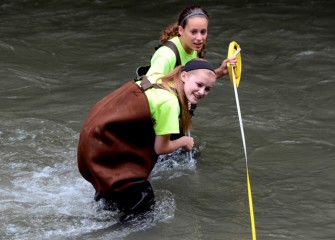 Sidney Chafee (foreground), from Solvay Middle School, and Madison Vanelli, from West Genesee Middle School, measure water velocity in a fast-moving Onondaga Creek.