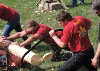 The SUNY College of Environmental Science and Forestry Woodsmen Team is the oldest student organization on campus, founded in 1912.  Here a team member uses a bow saw to cut a log; this activity is often done as a relay race in competition.