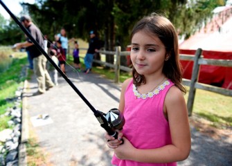 Mia Ennist of Oswego enjoys some trout fishing in the pond at Honeywell Sportsmen’s Days.