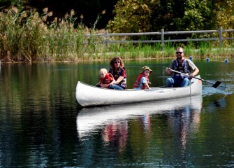 Gianna Commito and Scott Olson, from Kent, Ohio, take their children for a ride in a canoe.