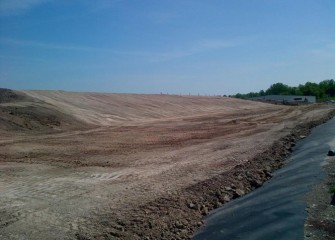 The first section of the leveling layer, in an area sloping from the top down along the south side, is complete.