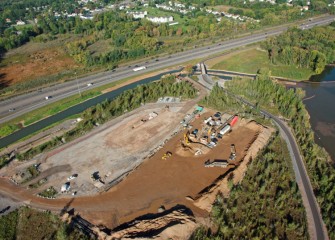 Material to create a clean creek bottom is stockpiled in a work support area near the Nine Mile Creek outlet.