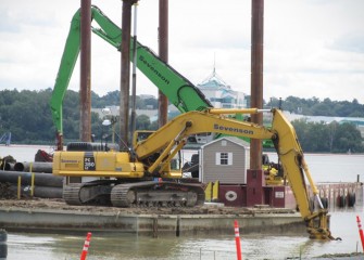 Mechanical capping takes place from two barges side by side.