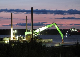 Daybreak nears after nighttime capping operations.  A hydraulic capping barge is visible to the right further out in the lake.
