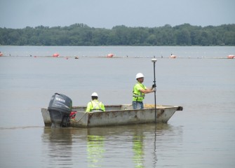 The capping team takes quality control measurements after material is placed by the telestacker.