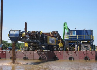 The telestacker (left) deploys a mixture of coarse gravel and sand in this location.