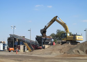 Sand is loaded into a hopper. The sand will travel up the conveyor and into a tank where it will be mixed with water for hydraulic capping.