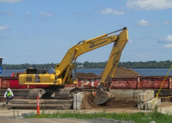 A barge is loaded with a mixture of sand and siderite to be placed near the mouth of Harbor Brook. Siderite is a mineral containing iron.