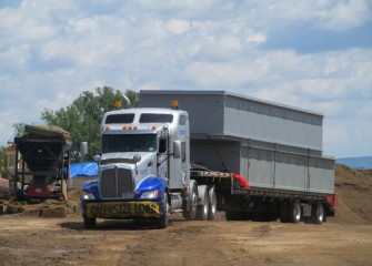 Sections for an additional capping barge to be built arrive.