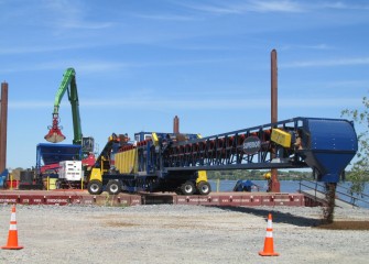 The telescoping radial stacking conveyor, or telestacker, is calibrated on shore before it is used in capping operations.