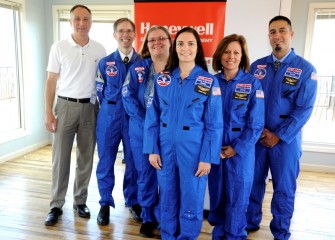 Honeywell Syracuse Program Director John McAuliffe welcomed and presented flight suits to 2016 Honeywell Educators at Space Academy (left to right) Stephen Bacon, Heather Bermingham, Susanne Sobon, Donna Erikson, and Carmen Primiano.