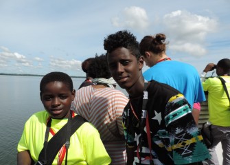 Isaac Kizza (left) and Abdi Hassan, from Syracuse City School District, enjoy starting out the week on a boat tour of the lake.