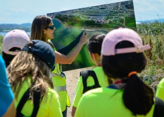 Students rotate through activities during the morning. This team is on the Onondaga Lake shoreline, where Parsons Environmental Engineer Natalia Cagide-Elmer shows how newly created wetlands are supporting diverse wildlife.