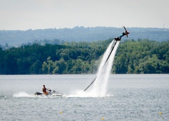 A flyboard, or jet board, demonstration takes place on the lake before heats, or preliminary races, of the corporate regatta begin.