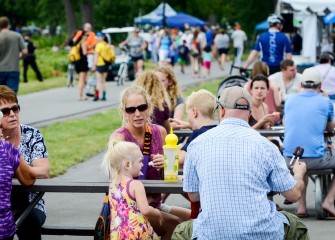 Individuals and families walk along the shoreline and stop to enjoy the fare offered by vendors along the way. Thousands enjoyed the Lakefest.