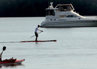 Some spectators observe race activities from a closer vantage point on the water.