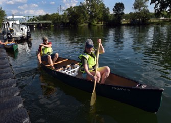 Rick Betty and Cari Brazie, from Brewerton, push off to head down Seneca River where most of the water chestnut will be pulled.