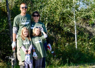 Mark and Elizabeth Bremer, of Manlius, brought daughters Sammie (left) and Ali to also volunteer. Corps members pledge to educate future generations about becoming caretakers of the water, air, land, and wildlife.