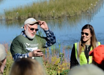 Corps volunteers Joe McMullen, habitat expert, and Natalia Cagide-Elmer, environmental engineer at Parsons, brief volunteers on native species they will plant in the new wetlands.