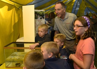 Honeywell Syracuse Program Director John McAuliffe enjoys viewing displays with Cub Scouts and others in attendance.