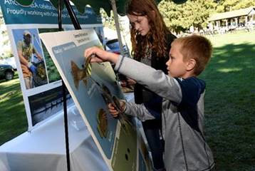 Above: 9-year-old John and 12-year-old Julia McCann, of Camillus, play a game to learn about fish species in Central New York.