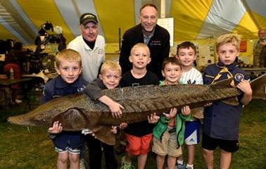 “For the past eight years, Honeywell has partnered with the Onondaga County Federation of Sportsmen’s Clubs to host Honeywell Sportsmen’s Days at Carpenter’s Brook. It is encouraging to see sportsmen passing down their knowledge of conservation practices to the next generation,” said Honeywell Syracuse Program Director John McAuliffe, pictured above (back right), with members of Cub Scout Pack 161, Den 7, of Skaneateles, and Tom Brooking (back left), from New York Sturgeon for Tomorrow.