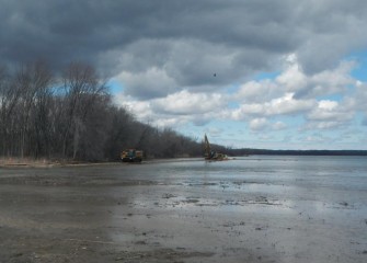 In spring work resumes building an access road along Nine Mile Creek and the shoreline, and placing equipment mats in the lake.