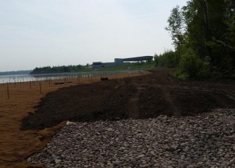 After planting, the shoreline is covered with topsoil.