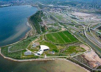 Near the western (left) and southwest shorelines (background), capping resumes to isolate remaining contaminants and create a new habitat layer in Onondaga Lake.