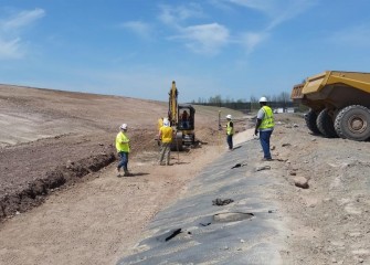 Channels around the perimeter for storm water flow are excavated, then surveyed to ensure proper slope.