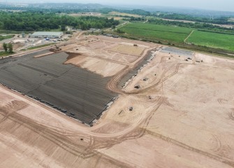 At the consolidation area, the polyethylene cover liner and additional soil layers are well under way.