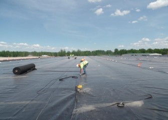 A worker seals cover liner sheets together.