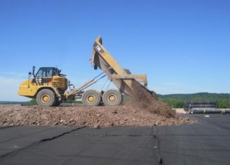 Construction of the soil layer on top of the liner begins.