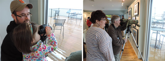 Visitors met the photographers who captured the images and had an opportunity to look for birds in their natural habitat with experts from the Montezuma Audubon Center and Onondaga Audubon Society. Left: Joe Kondratowicz, of Camillus, New York, helps his daughter Aeryn use binoculars to identify bird species. Right: Michele Neligan (left), a former Onondaga Audubon board member and a photographer exhibiting at the event, helps Peg Arinsen, of North Syracuse, New York, use a scope to identify a Red-breasted Merganser.