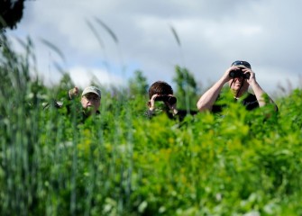 Paul Marconi (right), a member of the Onondaga Lake Conservation Corps since 2012, spots birds with Onondaga Audubon volunteers Paul Richardson (left) and Michele Neligan.