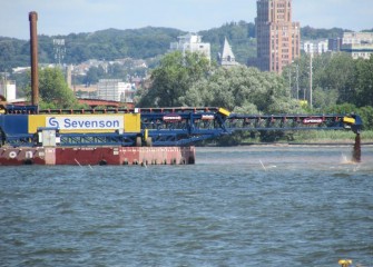 The telestacker places coarse gravel in the southern part of Onondaga Lake, creating a new lake bottom.