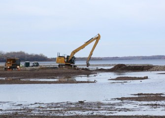 Topsoil placement occurs near the southwest corner of Onondaga Lake as capping operations wind down this year.