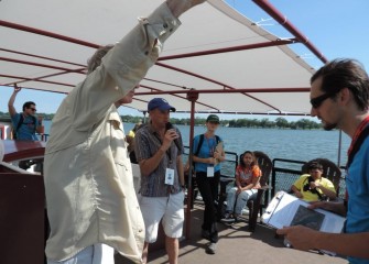 Syracuse University Professor of Environmental Systems Engineering and Distinguished Professor Charles Driscoll (center) speaks to students about the Onondaga Lake ecosystem and fish in the lake.