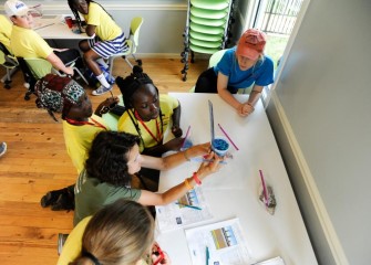 Students work on an exercise to simulate the lake cap and learn about the science behind Onondaga Lake bottom capping.