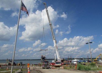 A booster pump is removed from a barge after hydraulic capping concludes.